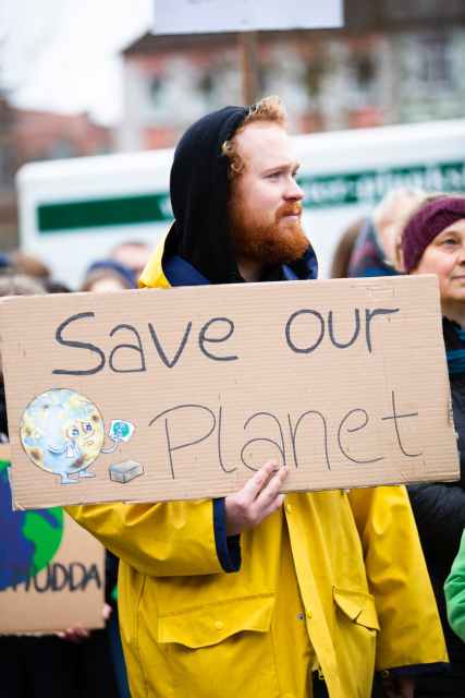 person holding save our planet sign